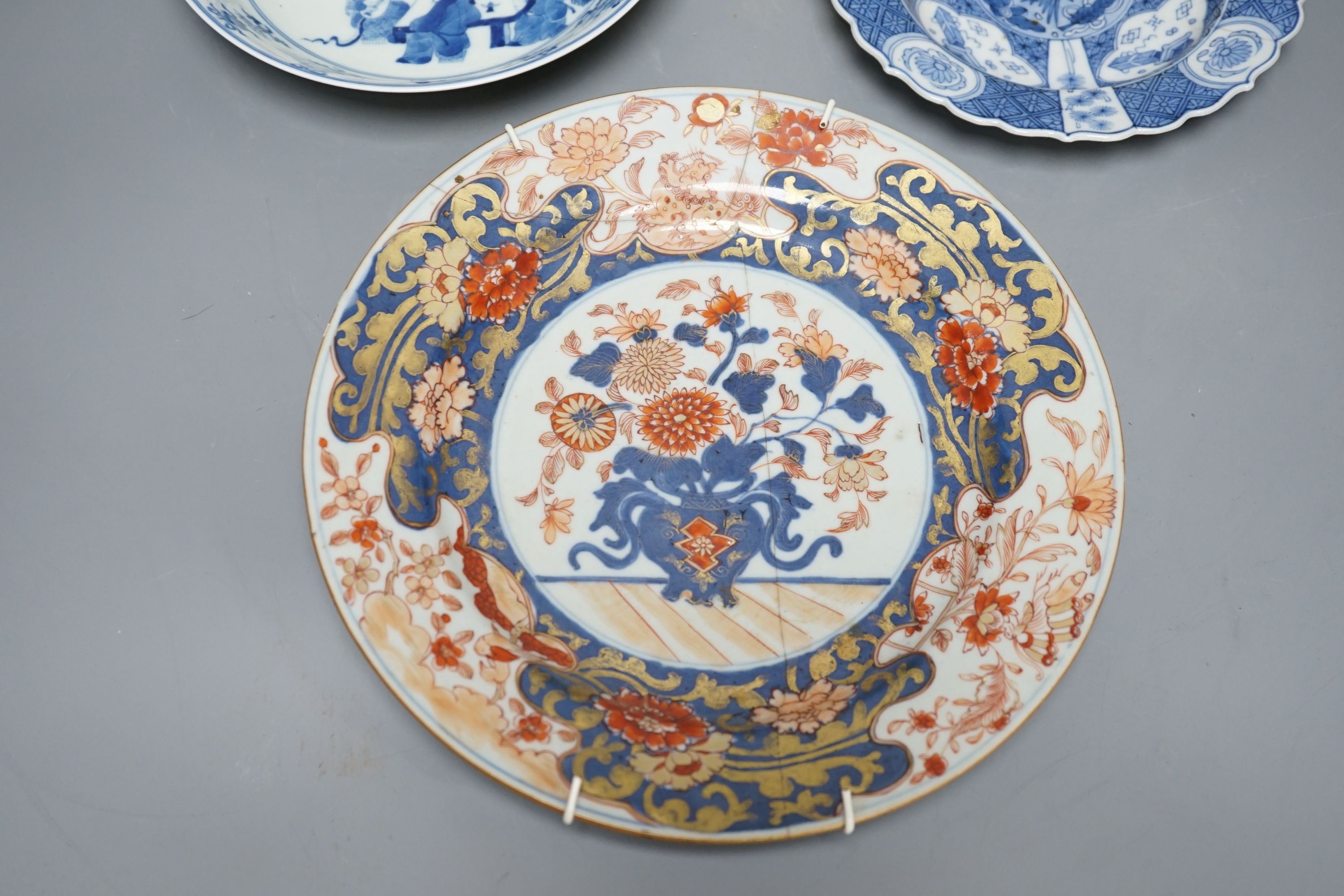 Three Chinese plates including a 19th century Chinese Imari dish, 23cm - repaired, a Chinese famille rose crackleglaze vase, 29cm, together with a famille rose teapot and a crackleglaze celadon ground bottle vase. Talles